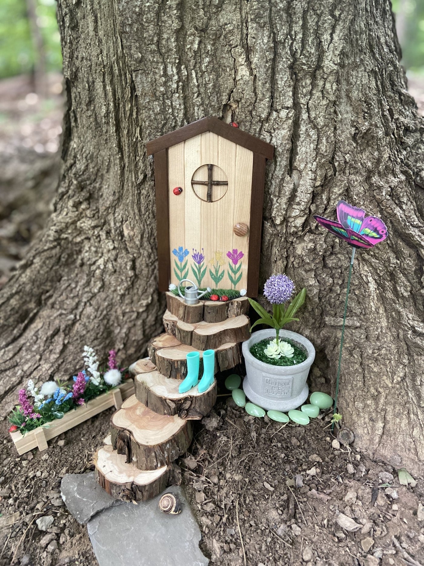 Fairy door with steps and flowers